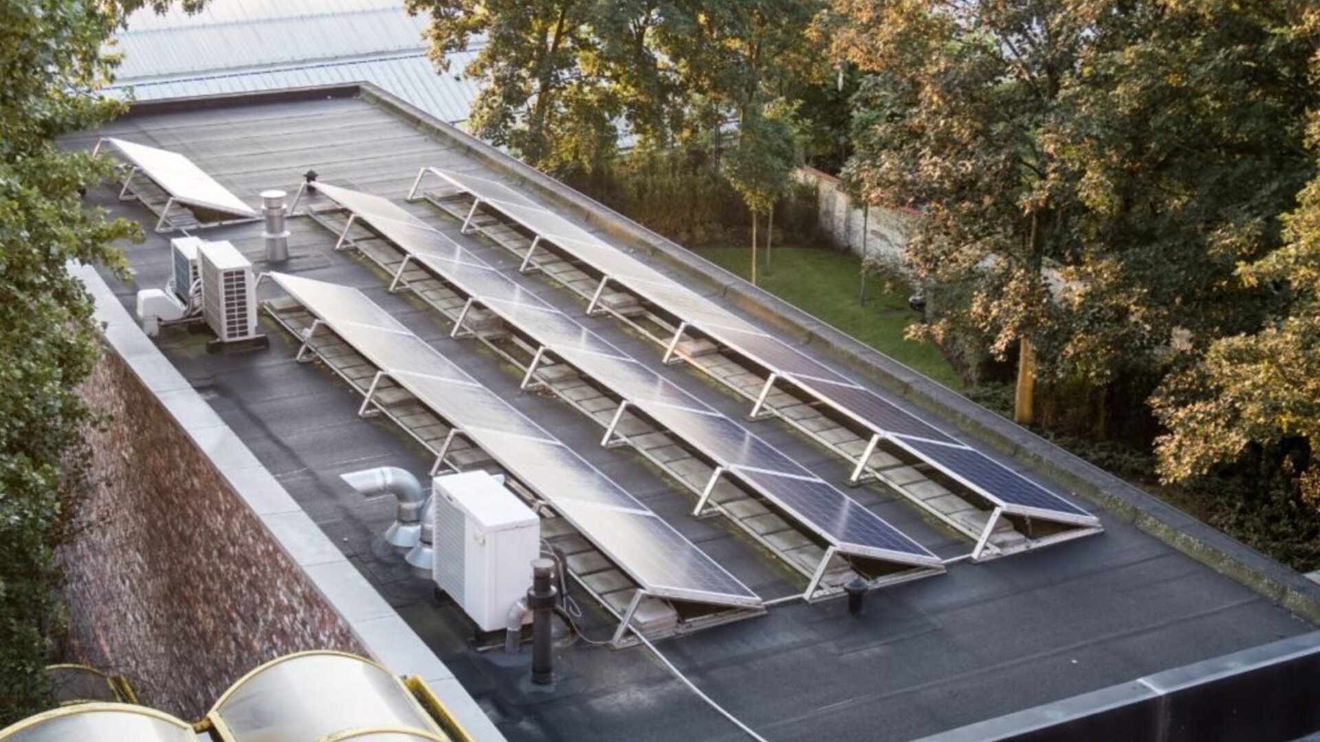 Commercial rooftop solar panels installed on a flat-roofed building
